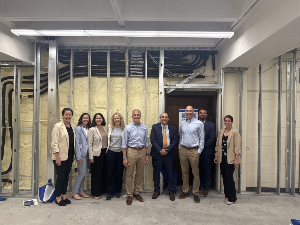 group shot inside NECC's tech tower, a room under construction