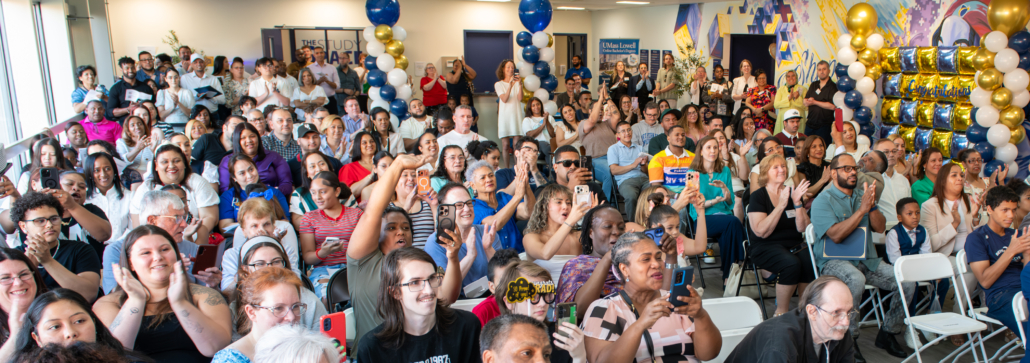 audience of supportive family, friends, and local staff at the CAE ceremony