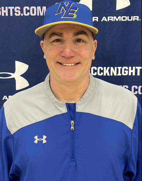 jeff smiles at camera wearing NECC baseball hat and windbreaker