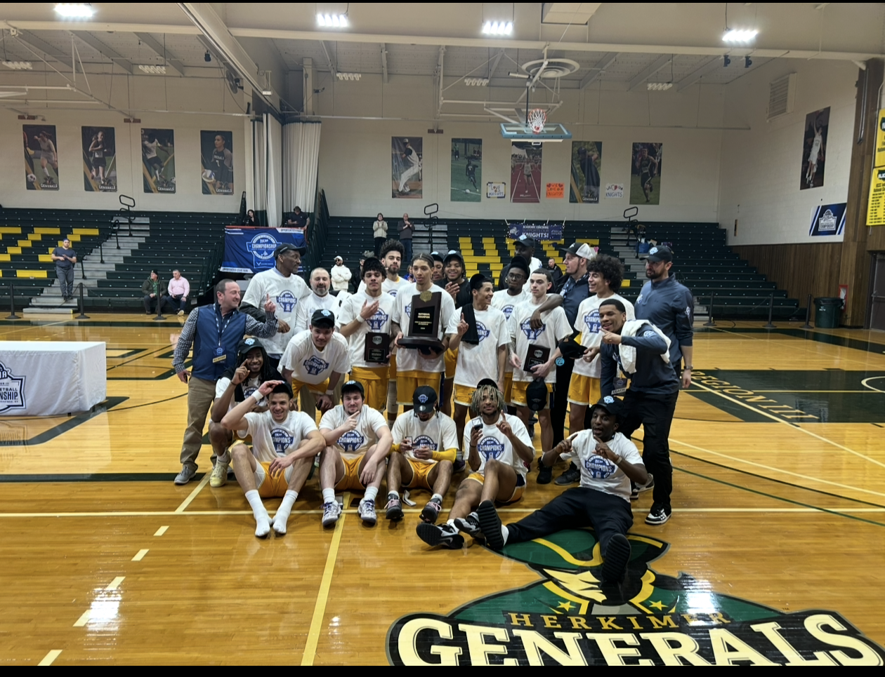 team poses together with championship trophy, many hold up their fingers to indicate number 1