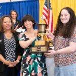 ASL Club members hold up trophy
