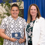 Ampa Cubias poses with award and Jody Carson