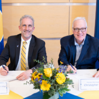 president glenn and president hopey pose with pens and paper