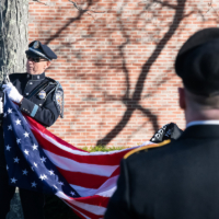 Police officer clips flag to pole