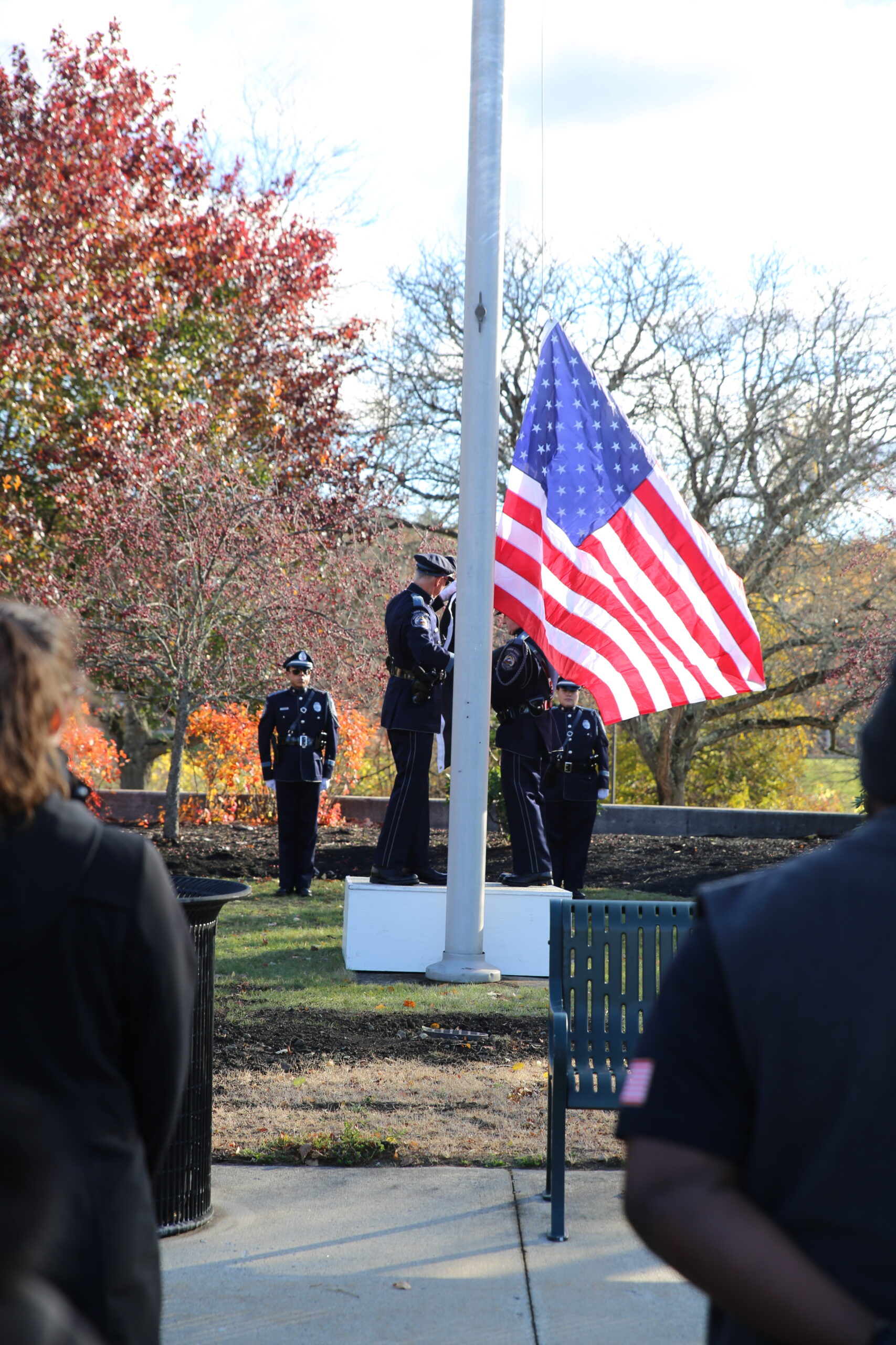 police officers raise flag