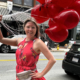 Hailey holding red balloons on the streets of Haverhill