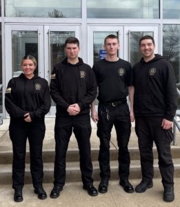 four student officers stand side by side smiling at the camera