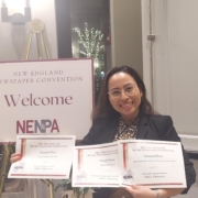 daniela holds up three award certificates