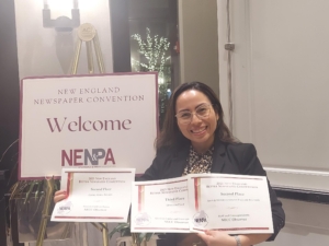 daniela holds up three award certificates
