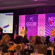 wide shot of stage with NISOD Banners and two people accepting an award