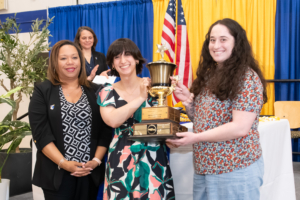 ASL Club members hold up trophy