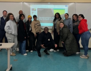 a group of students pose in front of projection screen
