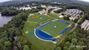 rendering of the new athletic field complex with bright blue track on the foreground and the baseball field behind it to the left