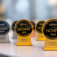 six awards sit on a desk