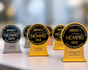 six awards sit on a desk