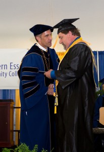 NECC President Lane Glenn presented Human Services graduate Bruce Augustonovich with his diploma. 