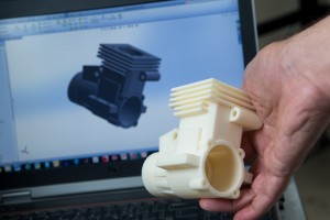 Using NECC’s new printer, Cahaly recently printed a two-stroke model engine block and heat sink that he modeled on his laptop computer.  Each part, which was the size of a small digital camera, took almost a day to print.