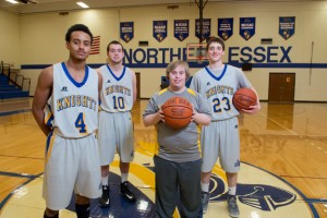Brett Hanley (center) with NECC Knights basketball players Bryon Centeno of Lawrence, Matt Jameson of Haverhill, and Matthew Lynch of Plaistow.