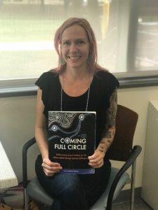 NECC Anthropology Professor Kristi Arford with the textbook she created 
