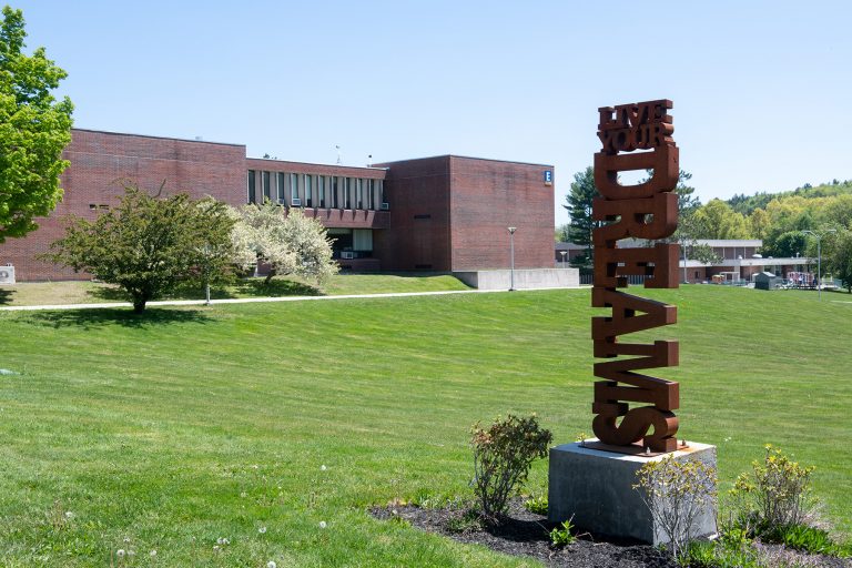 live your dreams statue with E science building in the background
