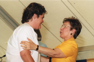 Sylvia Hallsworth (right) grants a pin to a graduating nursing student during the 1999 commencement. 