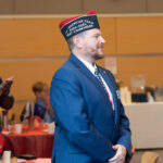 a veteran stands in honor