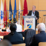 president glenn stands at podium addressing audience