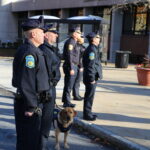 NECC campus police officers watch as flag is raised