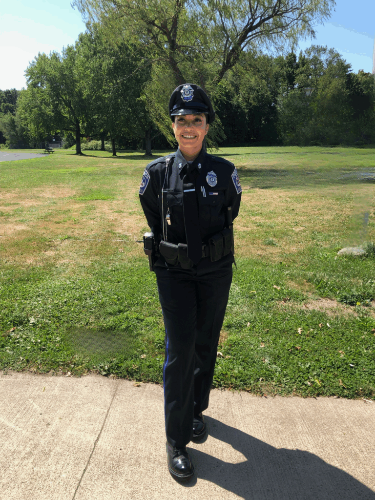 Hernandez stands in her uniform, smiling at the camera