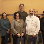 Three women and three men pose with their NECC gift bags