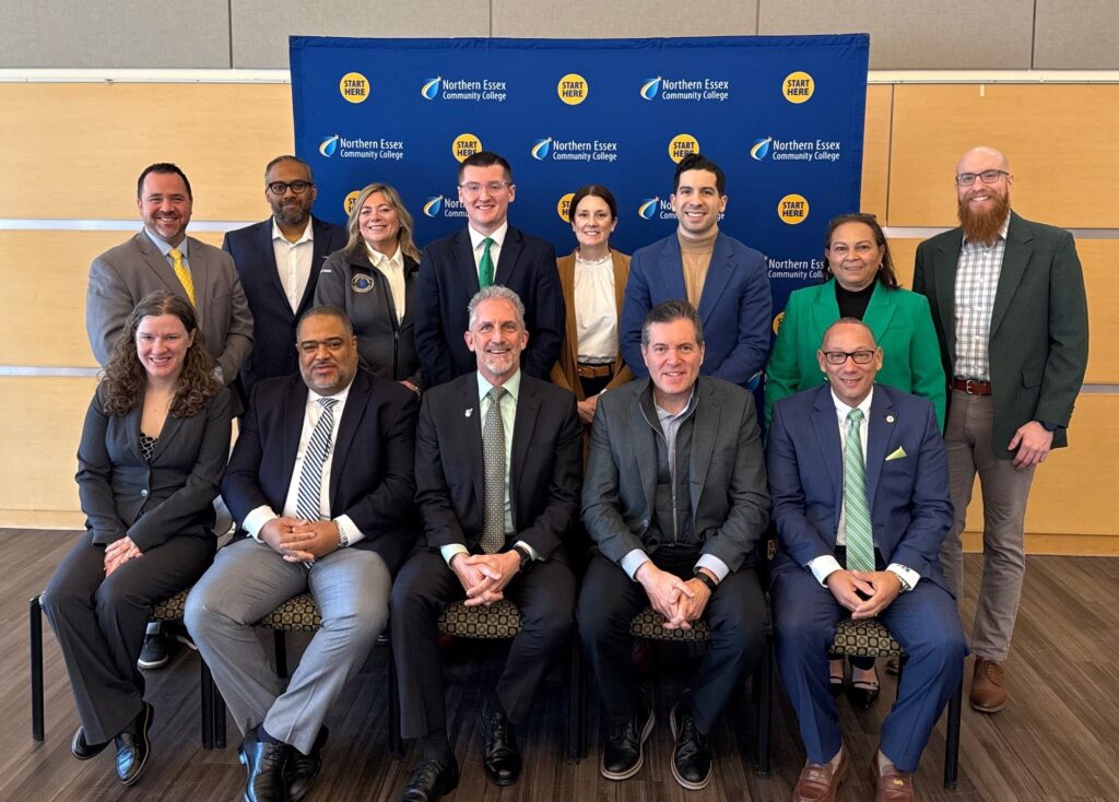 group shot of attendees, the front row is seated, the second row is stading behind them