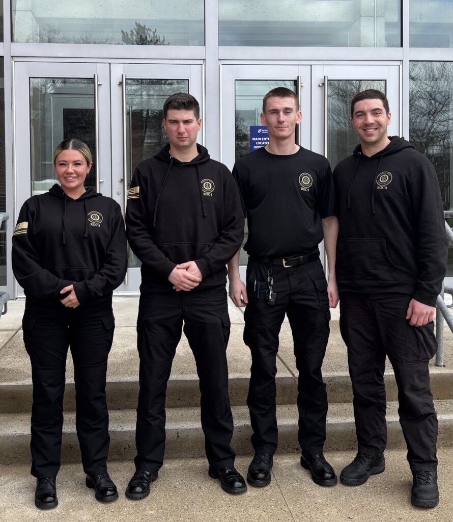 four student officers stand side by side smiling at the camera