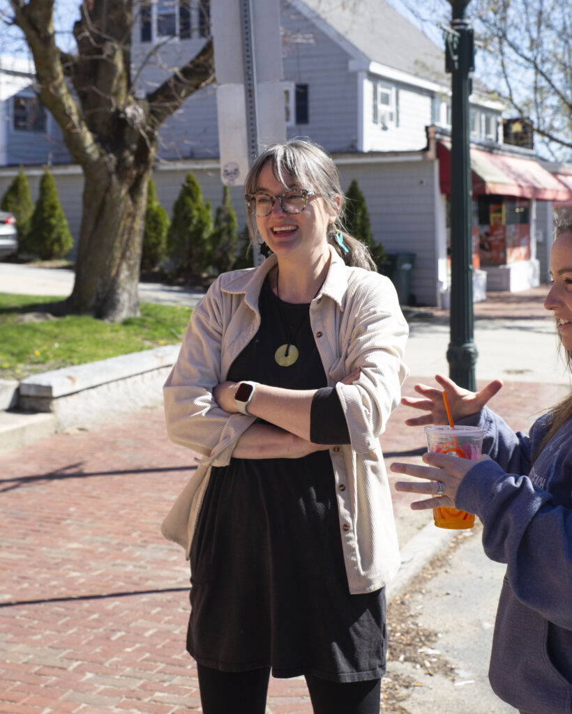 Professor Jenn Houle stands outside and smiles
