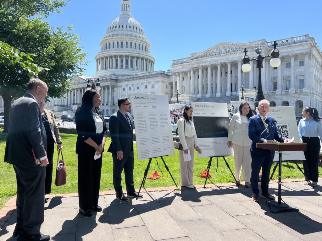 president glenn stands at a podium in front of the US capitol building