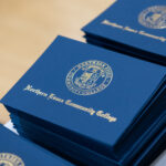 stack of award folders with NECC seal
