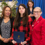 student poses with award and Dr Landers and Sarah Cooper