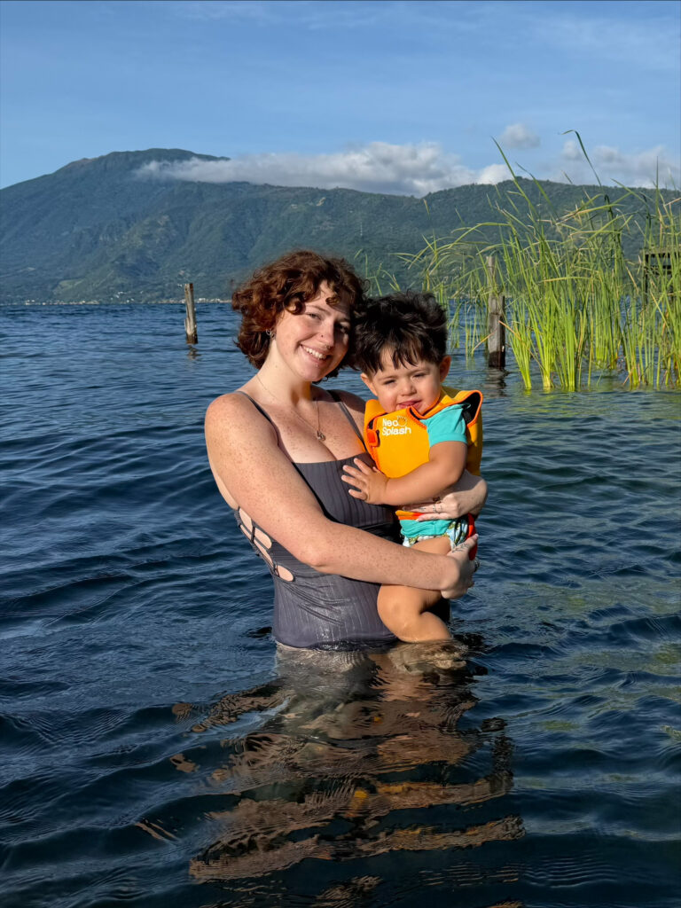 Mckenzie holds her son as they wade in a lake