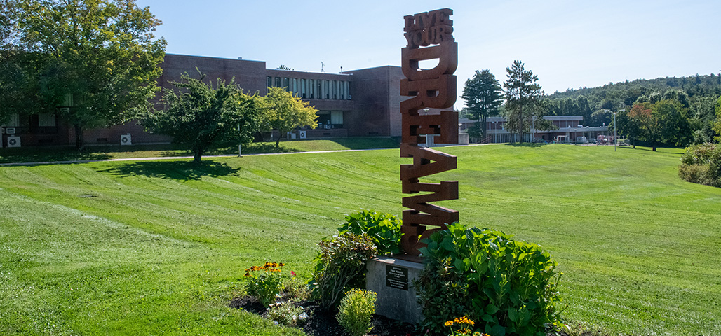 Photo of the Dream Statue by Dale Rogers on the Haverhill Campus during a brgight and sunny summer day