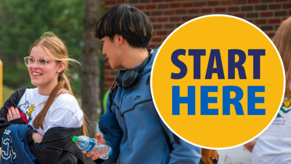 Start Here image with two students, one female presenting and one male, walking on the Haverhill campus engaged in conversation