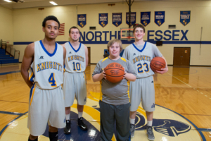 Brett Hanley (center) with NECC Knights basketball players Bryon Centeno of Lawrence, Matt Jameson of Haverhill, and Matthew Lynch of Plaistow.