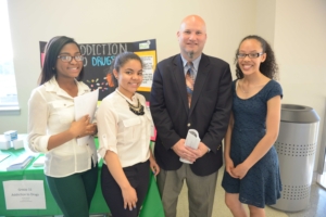 Lawrence Superintendent Jeff Riley with students (left to right) Wildaly Santana, Aysha Polanco, and Anabeliz Brito.