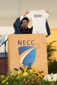 NECC President Lane Glenn exhibits a Stay+ tshirt which is the creation of graduate CJay DiPrima.