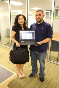 NECC librarians Susan Leonardi and Fred Curty display one of the Dell laptops and carry case available to NECC students through a new laptop lending program.