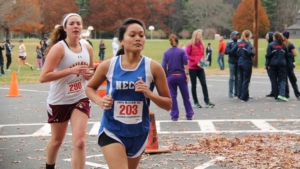 Two young woman participate in cross country running meet.