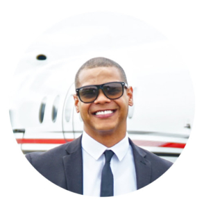 Young man wearing sunglasses and suit and tie.