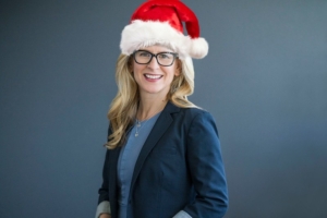 woman with blonde hair wearing a Santa hat