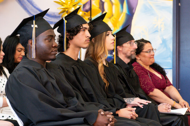 graduates seated in a row at the ceremony